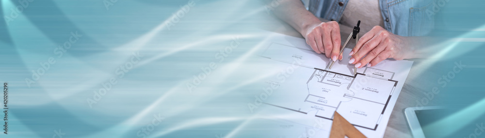 Female architect working on blueprint; panoramic banner Female architect working on blueprint; panoramic banner