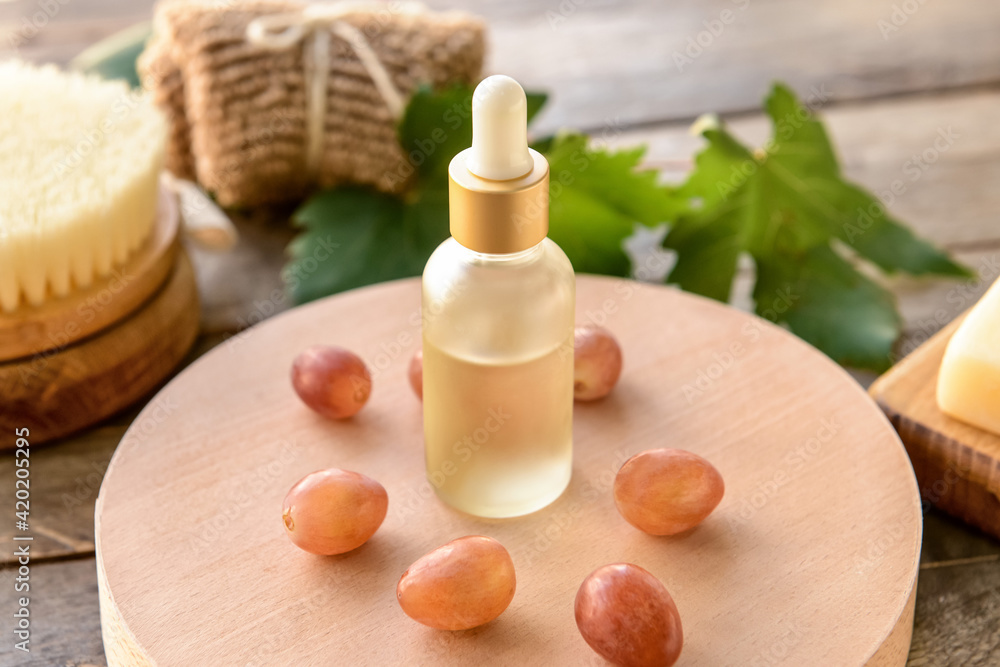 Bottle of grape seed oil on table Bottle of grape seed oil on table