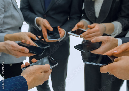 close-up of smartphones in the hands of business youth