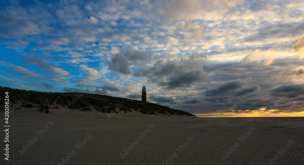 Beach landscape images with sunrise and sunset with lighthouse