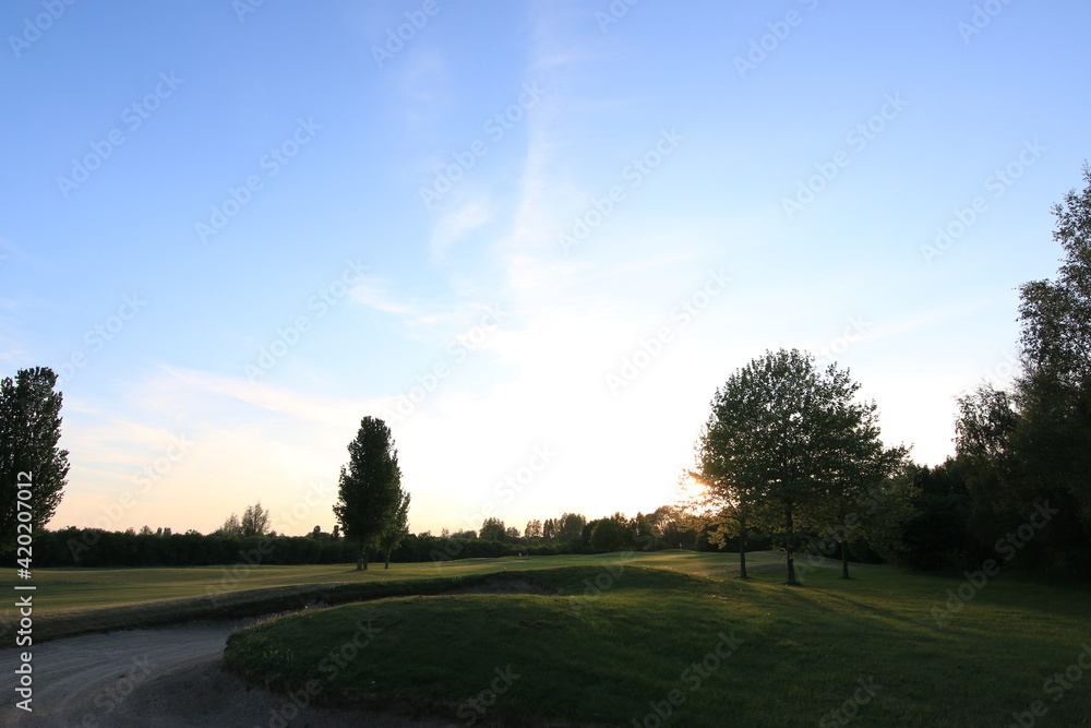 Golfcourse with beautiful sky and lights with green grass Golfcourse with beautiful sky and lights with green grass