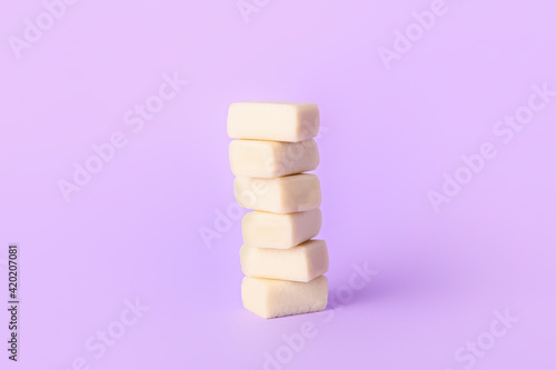 Tasty chewing gums on color background