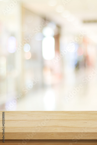 Vertical wood table background and blur background, Empty wooden counter, shelf surface over blur restaurant with bokeh background, store product display backdrop, banner, mock up, template