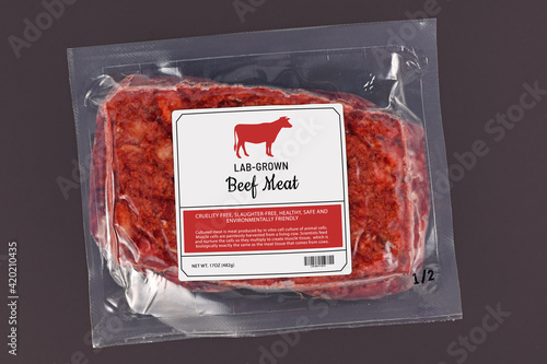 Lab grown cultured meat concept for artificial in vitro cell culture meat production with frozen packed raw meat with made up label on dark background photo