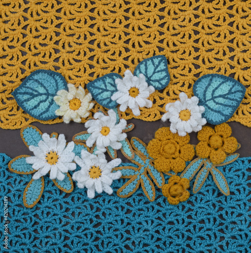 Decorative flowers on a yellow and blue fabric background.