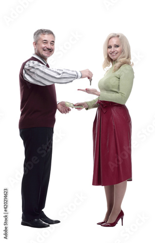 smiling man handing keys to a young woman . isolated on a white