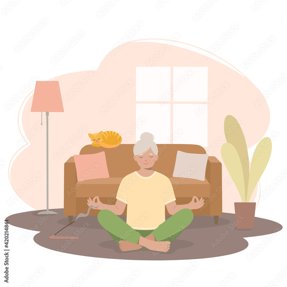 Senior woman meditating. Woman in a yoga pose, in a lotus position in the living room.