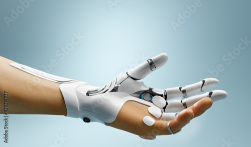 Tableau sur toile Robotic bionic hand connected with human hand.