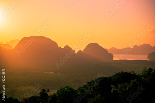 Panoramic nature background  mountains  sea  trees  twilight lights in the sky  waterfront communities   naturally blurred through the wind  seen on tourist spots or scenic spots
