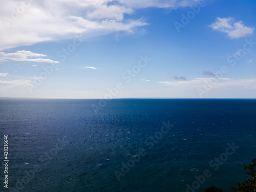 Genova  Italy - March 12  2021 - Seascape  blue sky  clouds and sea in the tropical waters of the Mediterranean sea in winter days.