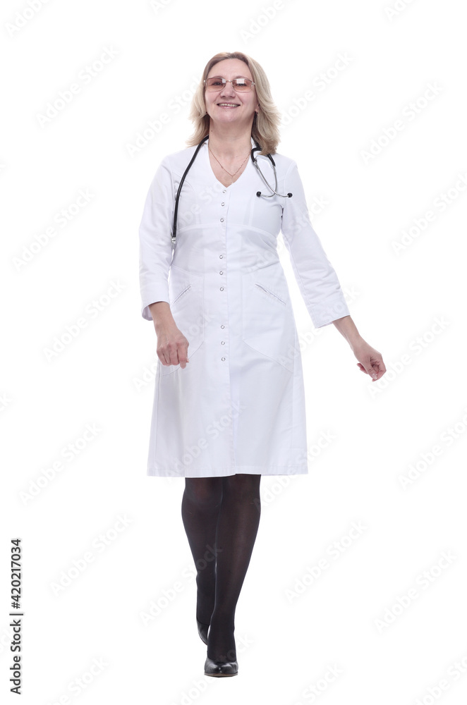 in full growth. smiling woman doctor striding confidently forward. in full growth. smiling woman doctor striding confidently forward.