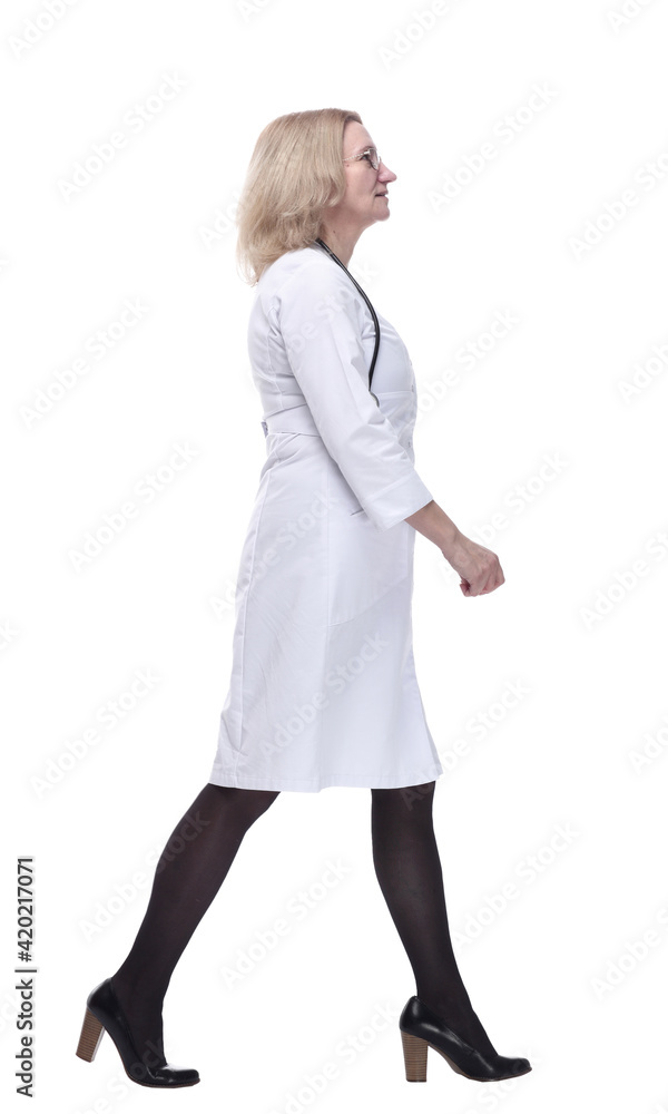 in full growth. smiling woman doctor striding confidently forward. in full growth. smiling woman doctor striding confidently forward.