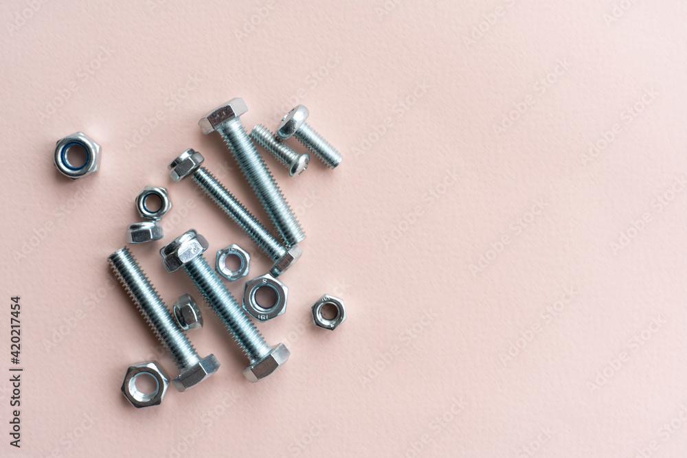 silver stainless steel nuts and bolts flat lay on the table, minimalistic concept silver stainless steel nuts and bolts flat lay on the table, minimalistic concept