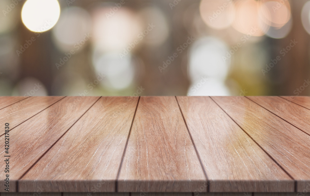 Empty wooden table top with lights bokeh on blur restaurant background. Empty wooden table top with lights bokeh on blur restaurant background.