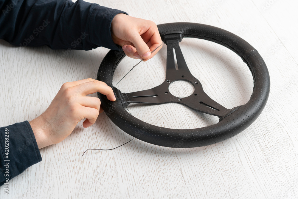 replace the car steering wheel eco leather trim material, Stock Photo