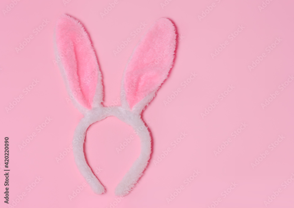 Funny Easter bunny ears on pink background. Top view. Copy space for text.Happy Easter,