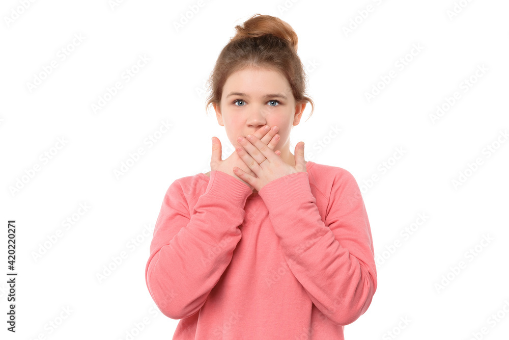 young girl 12-14 years old shocked covering mouth by hands for mistake, looks in terror at camera young girl 12-14 years old shocked covering mouth by hands for mistake, looks in terror at camera