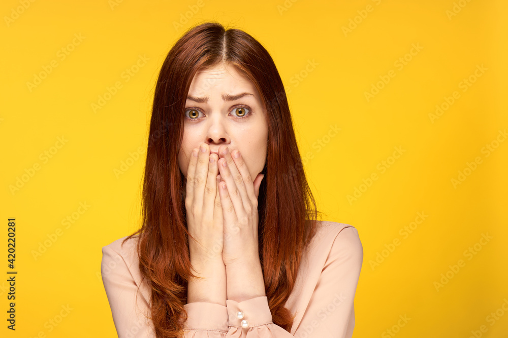 attractive woman holding hand near face charm emotion yellow background attractive woman holding hand near face charm emotion yellow background