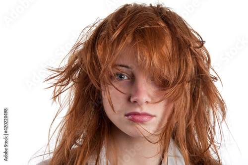 Sensual look of a girl with disheveled red hair and beautiful lips. Isolated