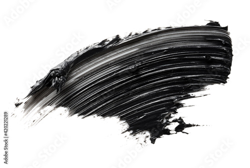 Smudged black mascara isolated on white background. Cosmetic product swatch. Paint brush stroke photo
