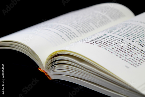 Opened book on black background