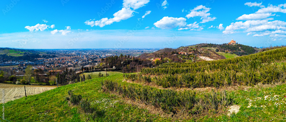 panoramic view hills Bologna italy city in colorful bright spring day with basilica of San Luca horizontal background