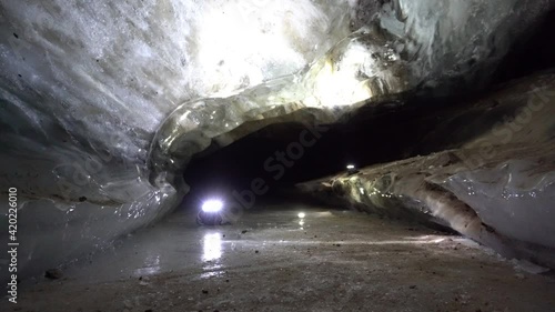 In the mountains inside the Bogdanovich glacier, in an ice cave. Snow and ice of interesting shapes grow on the walls of the cave. Stalactites hang. Huge ice walls and rocks. Sometimes macro. Almaty photo