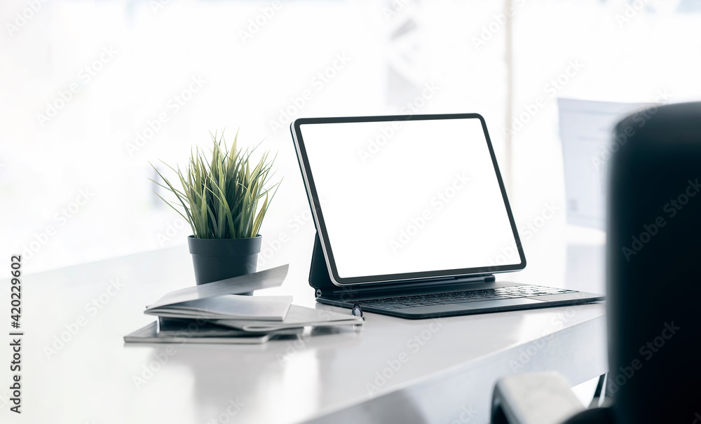 Fototapeta premium office desk with mock-up computer devices, supplies and decorations on white table.