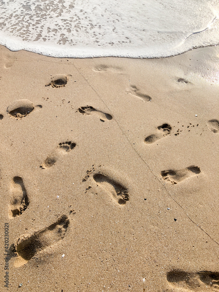 foot prints on the sandy beach in summer foot prints on the sandy beach in summer