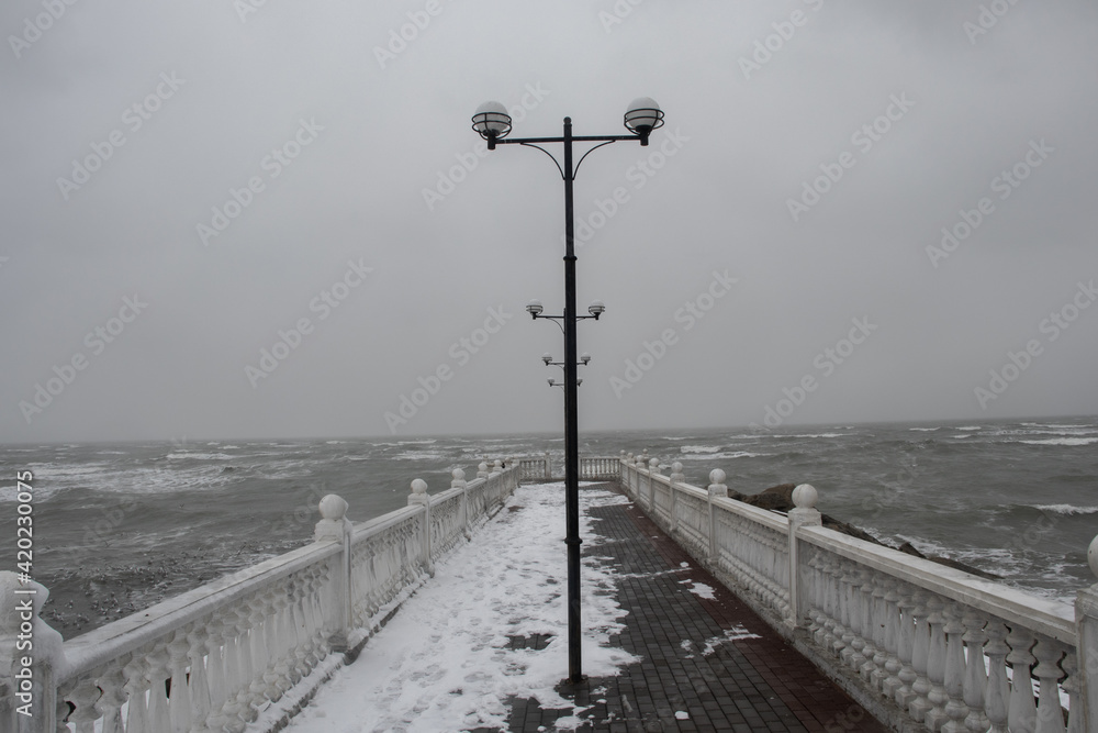 street light against a blue sky background. Street lights on the background of the sea. Street lamps in one row
