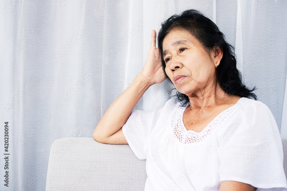 stressed old Asian woman sitting lonely at home feeling sad and depressed stressed old Asian woman sitting lonely at home feeling sad and depressed