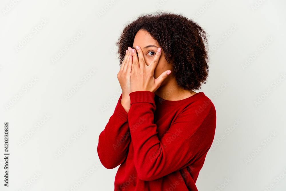 Young african american mixed race woman isolated blink through fingers frightened and nervous. Young african american mixed race woman isolated blink through fingers frightened and nervous.