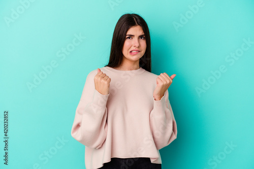 Young caucasian woman isolated on blue background showing that she has no money.