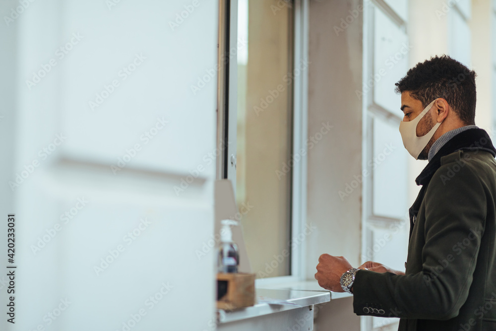 Young man waiting for his order outdoors