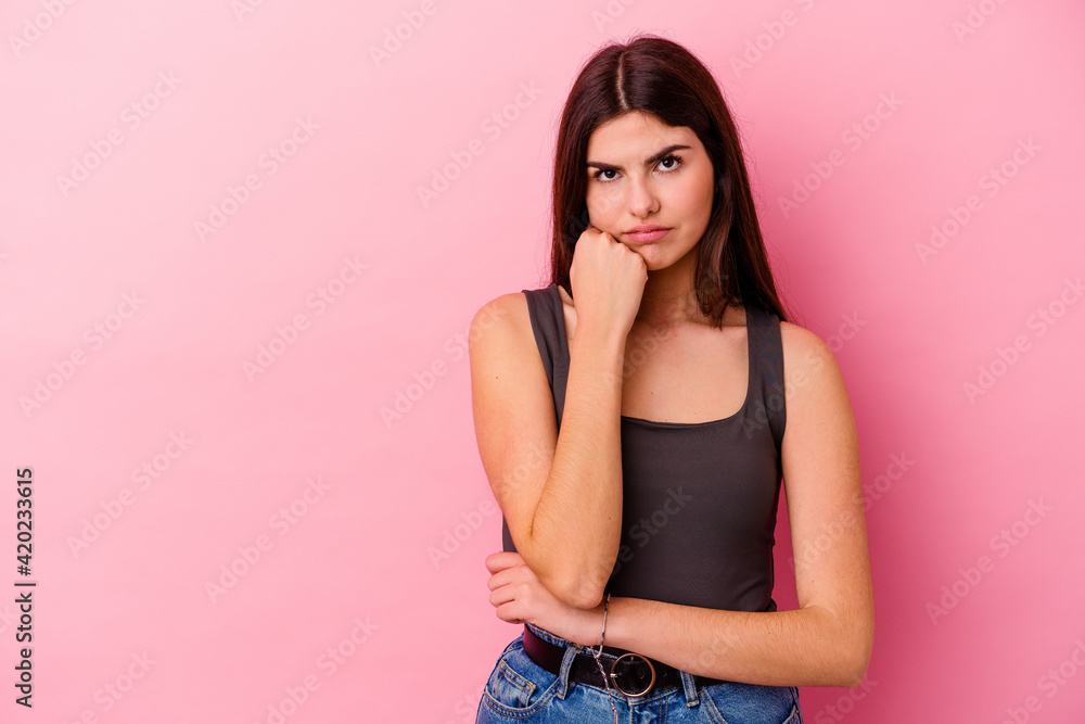 Young caucasian woman isolated on pink background who feels sad and pensive, looking at copy space. Young caucasian woman isolated on pink background who feels sad and pensive, looking at copy space.