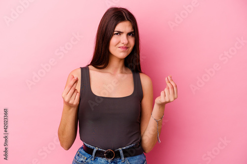 Young caucasian woman isolated on pink background showing that she has no money. © Asier