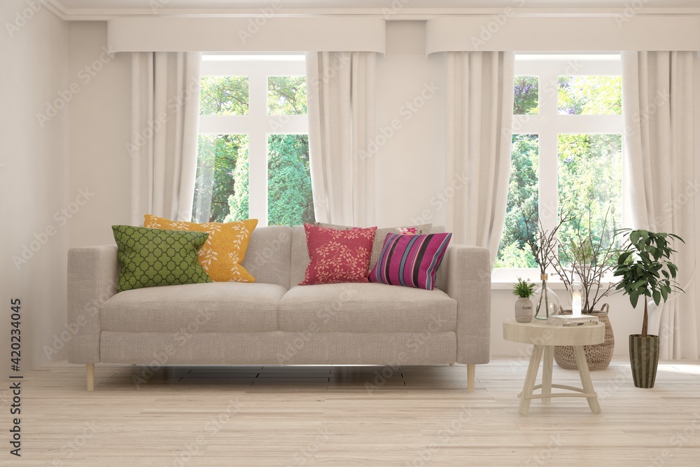 Fototapeta premium White living room with sofa and summer landscape in window. Scandinavian interior design. 3D illustration