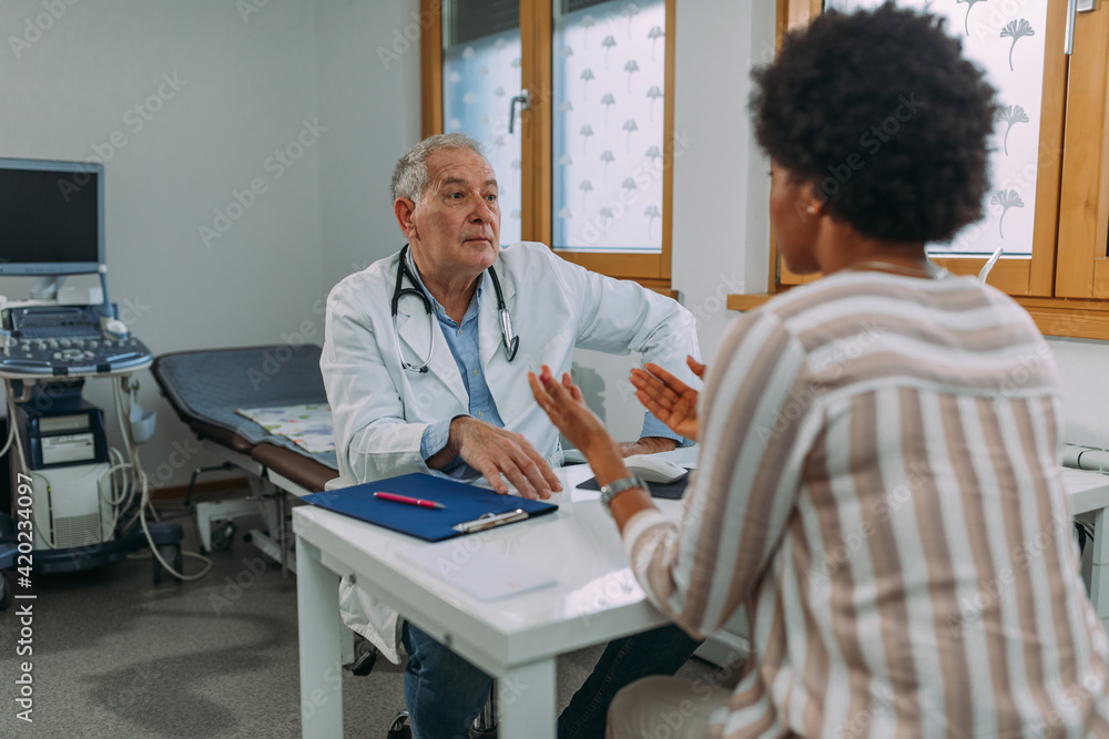 Senior doctor and his patient during examining at hospital Senior doctor and his patient during examining at hospital