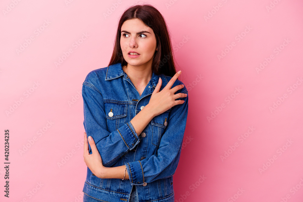 Young caucasian woman isolated on pink background confused, feels doubtful and unsure. Young caucasian woman isolated on pink background confused, feels doubtful and unsure.