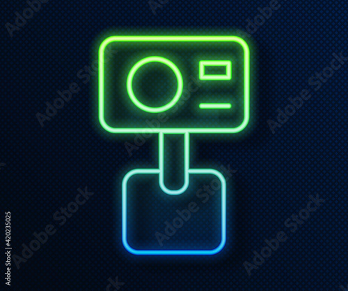 Glowing neon line Action extreme camera icon isolated on blue background. Video camera equipment for filming extreme sports. Vector