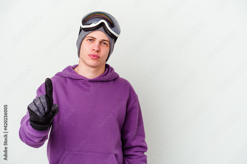 Young man holding a snowboard board isolated on white background showing number one with finger. Young man holding a snowboard board isolated on white background showing number one with finger.