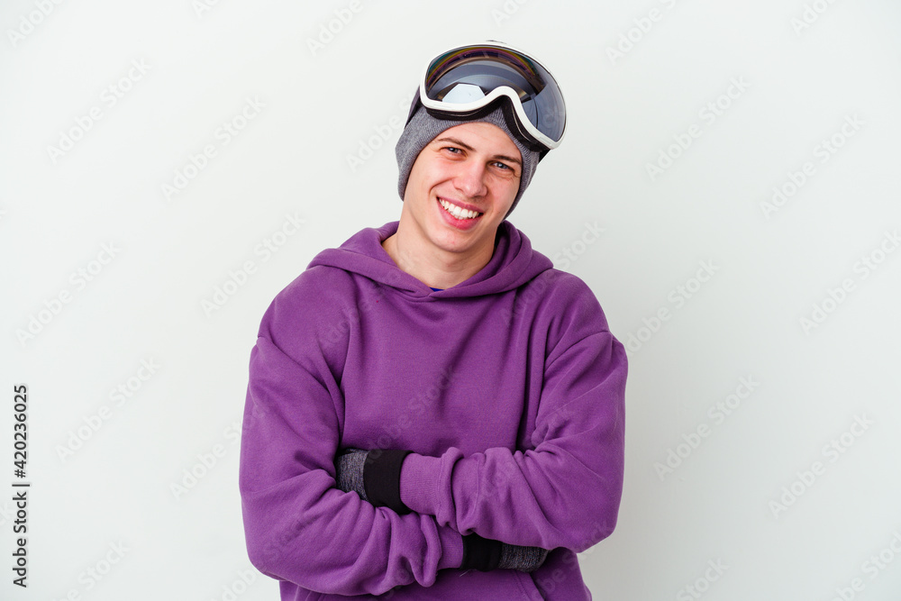 Young man holding a snowboard board isolated on white background laughing and having fun. Young man holding a snowboard board isolated on white background laughing and having fun.