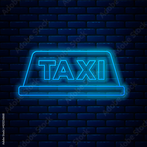 Glowing neon line Taxi car roof icon isolated on brick wall background. Vector