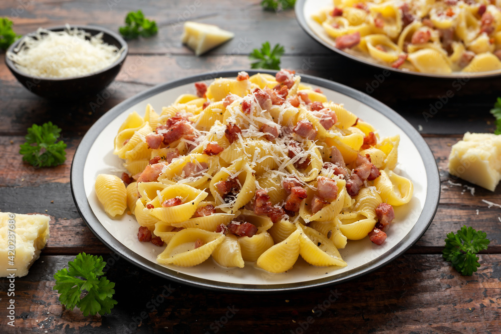 Classic Pasta carbonara with bacon, egg, cream, black pepper and Parmesan Cheese on plate. Italian food Classic Pasta carbonara with bacon, egg, cream, black pepper and Parmesan Cheese on plate. Italian food