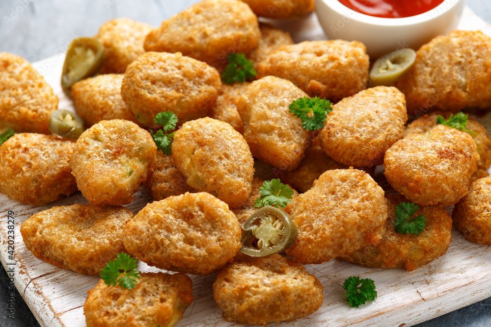 Crispy Jalapeno Popper with creamy cheese battered on white wooden board Crispy Jalapeno Popper with creamy cheese battered on white wooden board