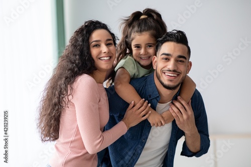 Portraif Of Happy Young Arabic Family Of Three With Little Daughter photo