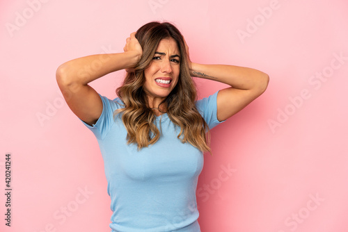 Young caucasian woman isolated covering ears with hands.