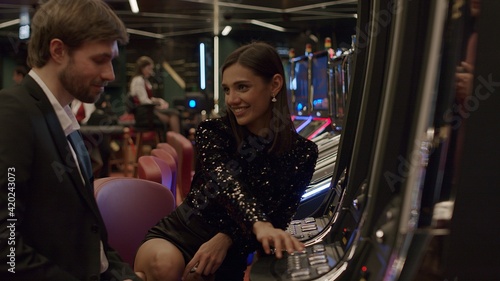 Young couple playing slot machine