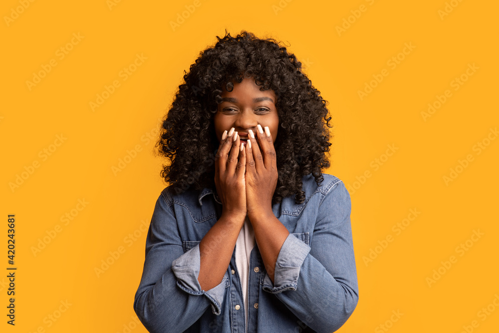 Shocked black woman covering her mouth with hands Shocked black woman covering her mouth with hands