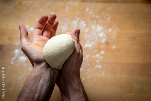 chef shaping pizza dough balls